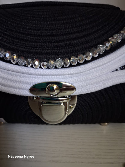 Black, white, and silver rope purse