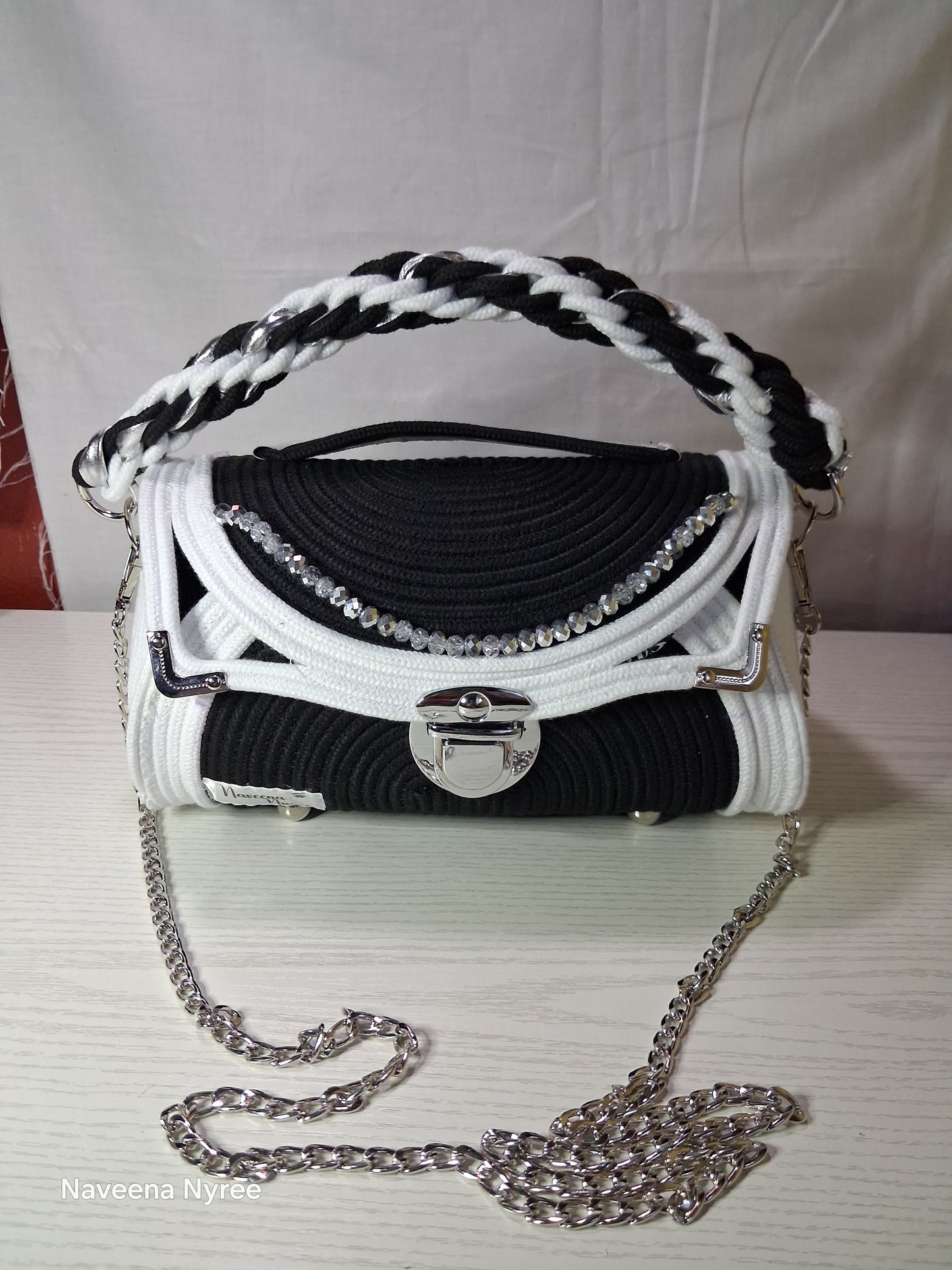 Black, white, and silver rope purse